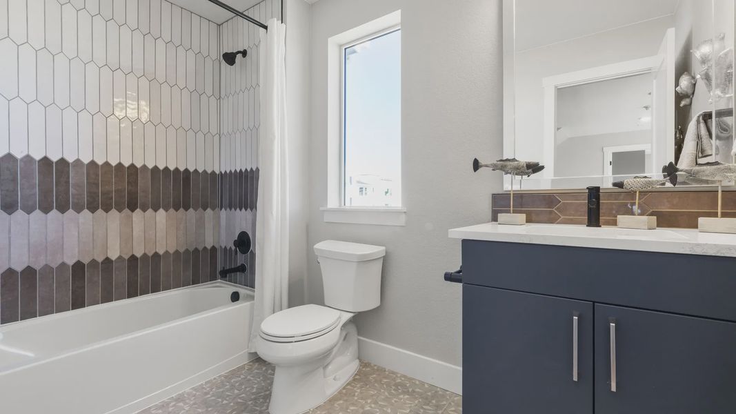 Luxurious bathroom showcasing intricate wall tiles and modern fixtures in Dillon Pointe. Luxurious bathroom showcasing intricate wall tiles and modern fixtures in Dillon Pointe.