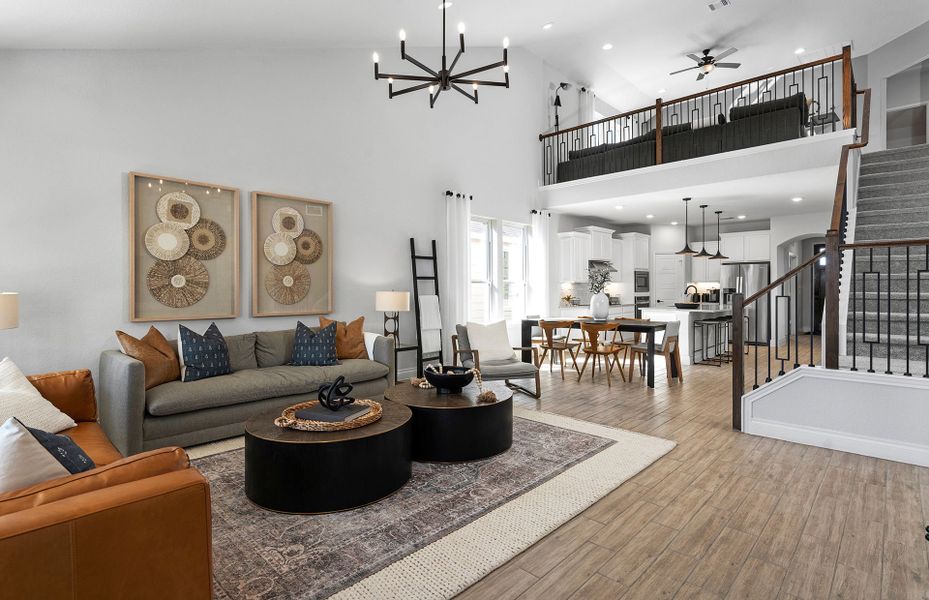 Loft overlooking open-concept gathering room and dining in Lily Springs new construction in Seguin