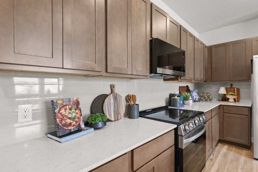 A kitchen with wooden cabinets.