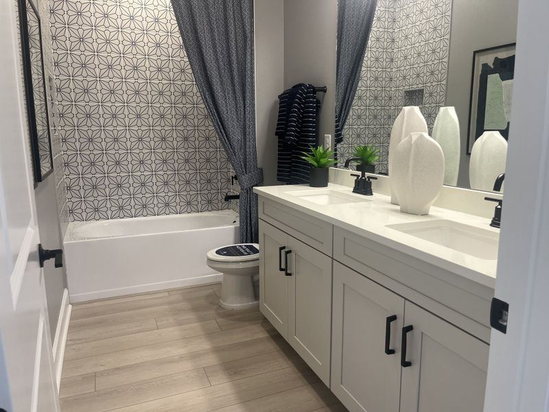 A chic bathroom with patterned tile, dual sinks, and elegant decor enhances modern living. A chic bathroom with patterned tile, dual sinks, and elegant decor enhances modern living.