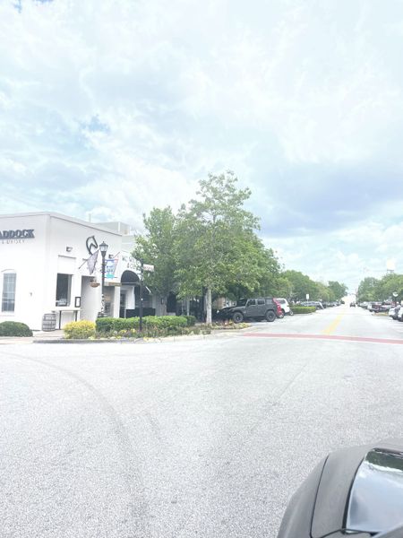 A quaint streetscape with trees and shops in Rivers Edge by DRB Homes, North Charleston, SC.