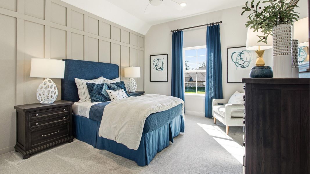 Generously sized guest room with decorative trim and abundant sunlight