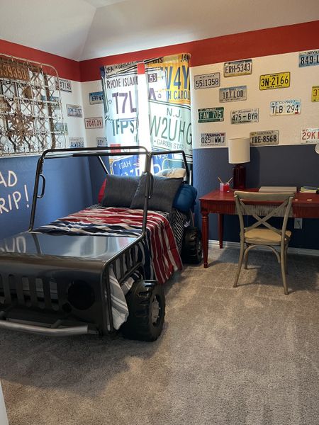 A playful bedroom with a car-themed bed, license plate decor, and a cozy study area, perfect for a young car enthusiast. A playful bedroom with a car-themed bed, license plate decor, and a cozy study area, perfect for a young car enthusiast.