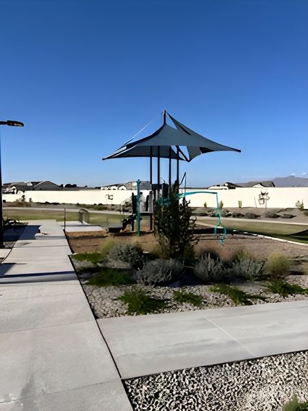 A scenic playground with modern equipment and landscaping in Grove at Lehi by Blandford Homes (Mesa, AZ).