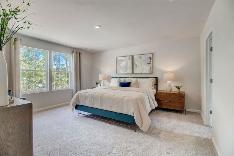 A bedroom with a bed and a window.