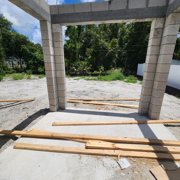 A construction site with block pillars and wooden beams in Palm Bay by D.R. Horton (Palm Bay, FL).