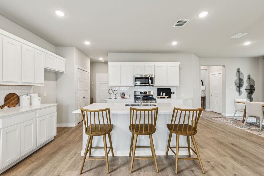 REPRESENTATIVE PHOTO – Kitchen in a Lakehaven Oak model home in Farmersville TX by Trophy Signature Homes