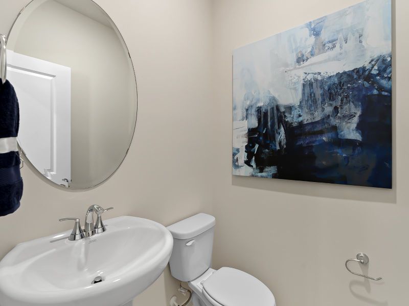 The downstairs half-bathroom provides convenient access for guests.