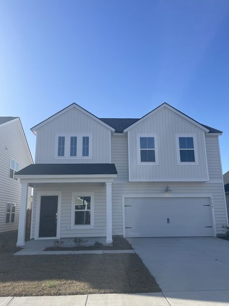 A modern two-story white home with sleek lines and a spacious garage in Sweetgrass at Summers Corner by Lennar (Ridgeville, SC).