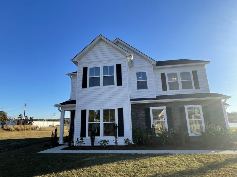 A charming two-story home with black shutters in Timothy Lakes by Center Park Homes (Ridgeville, SC).