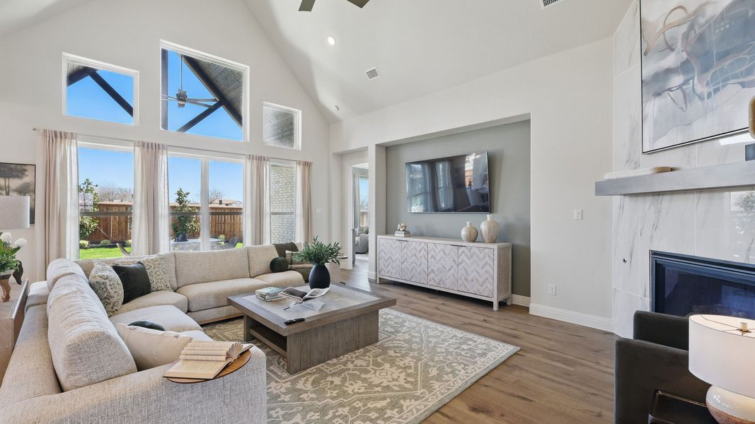 Luxurious living room features vaulted ceilings, elegant fireplace, and chic decor. Rio Vista at Kelly Ranch. Luxurious living room features vaulted ceilings, elegant fireplace, and chic decor. Rio Vista at Kelly Ranch.