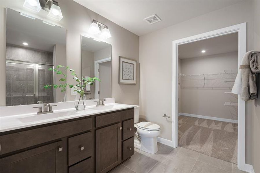 Spacious primary bath featuring a walk-in shower designed for comfort and relaxation.