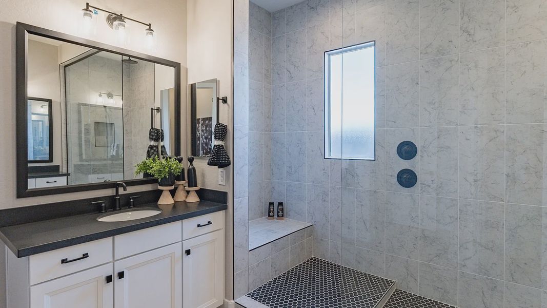Exquisite glass shower with marble tiles and a sleek black countertop in Arroyo Seco Hacienda. Exquisite glass shower with marble tiles and a sleek black countertop in Arroyo Seco Hacienda.