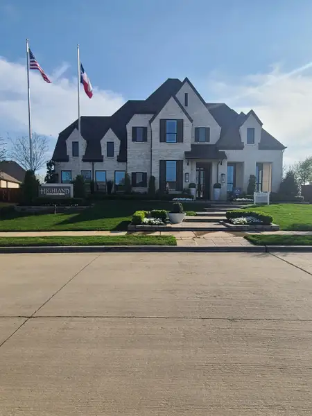 A stunning white brick home with lush landscaping in Star Trail: 86ft. lots by Highland Homes (Prosper, TX). A stunning white brick home with lush landscaping in Star Trail: 86ft. lots by Highland Homes (Prosper, TX).