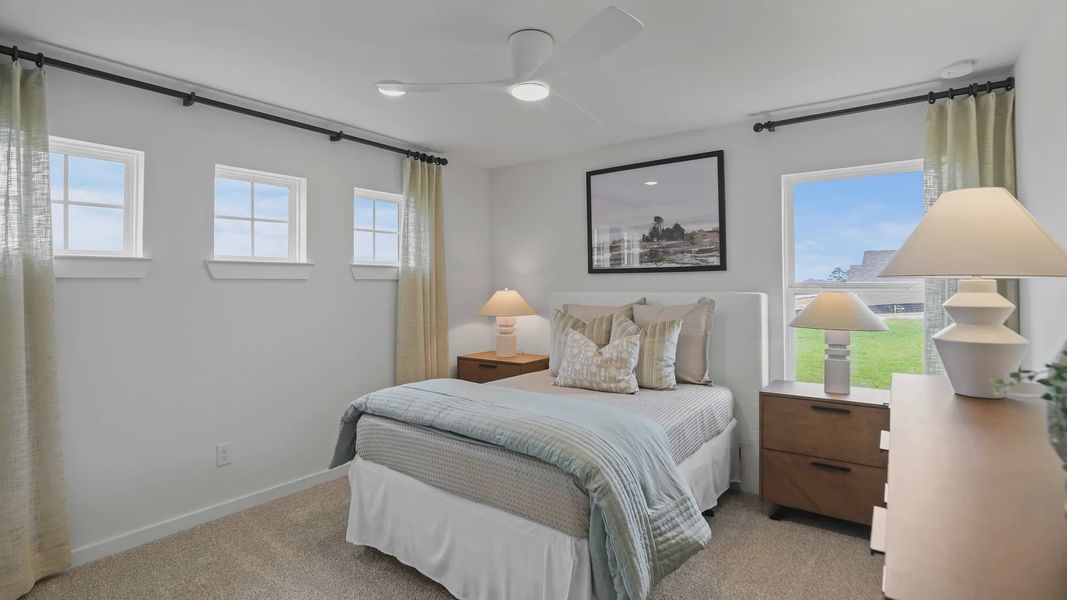 Sophisticated bedroom features plush carpet, sleek ceiling fan, and ample natural light in Mostyn Springs. Sophisticated bedroom features plush carpet, sleek ceiling fan, and ample natural light in Mostyn Springs.