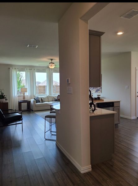 An inviting open-concept living area with warm wood floors, natural light, and cozy seating.