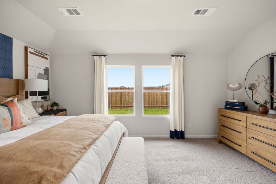 A bedroom with a large window. A bedroom with a large window.