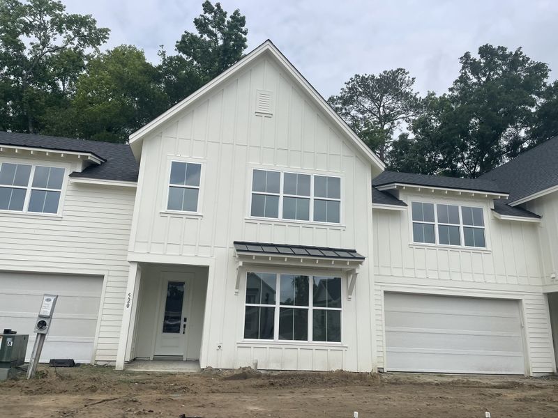 A charming white-paneled home with large windows in Hayes Park by New Leaf Builders (Johns Island, SC). A charming white-paneled home with large windows in Hayes Park by New Leaf Builders (Johns Island, SC).