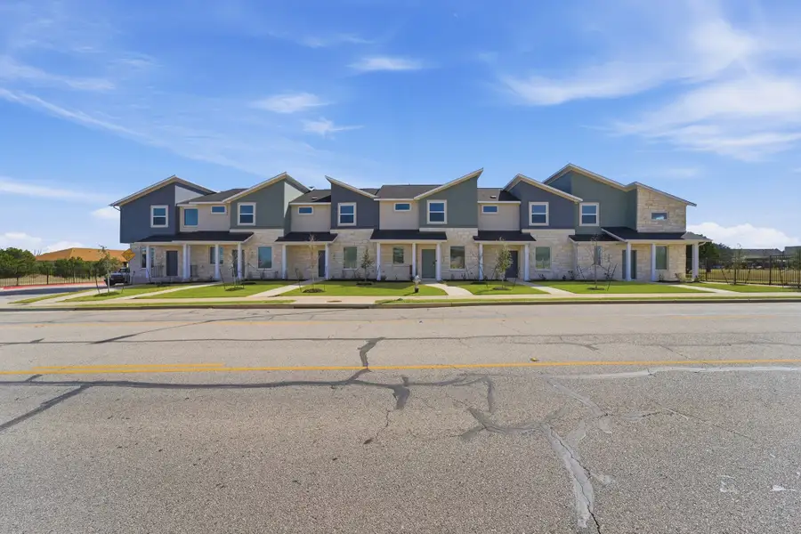 Front exterior of a home in the Municipal Drive Townhomes community, located in Leander, TX (Image 5).