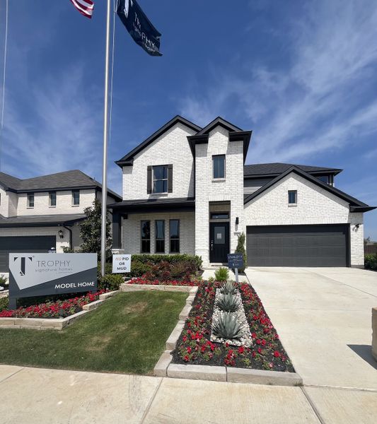 A beautiful white brick home with elegant landscaping in Tesoro at Chisholm Trail Ranch by Trophy Signature Homes (Fort Worth, TX). A beautiful white brick home with elegant landscaping in Tesoro at Chisholm Trail Ranch by Trophy Signature Homes (Fort Worth, TX).