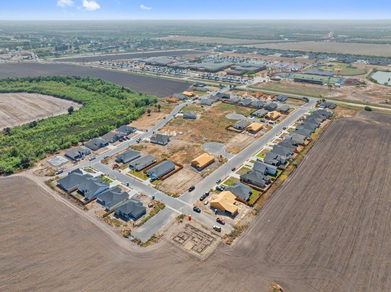 Aerial view of the The Heights at Riverbend II community in Brownsville, TX, showing layout and nearby surroundings (Image 12). Aerial view of the The Heights at Riverbend II community in Brownsville, TX, showing layout and nearby surroundings (Image 12).