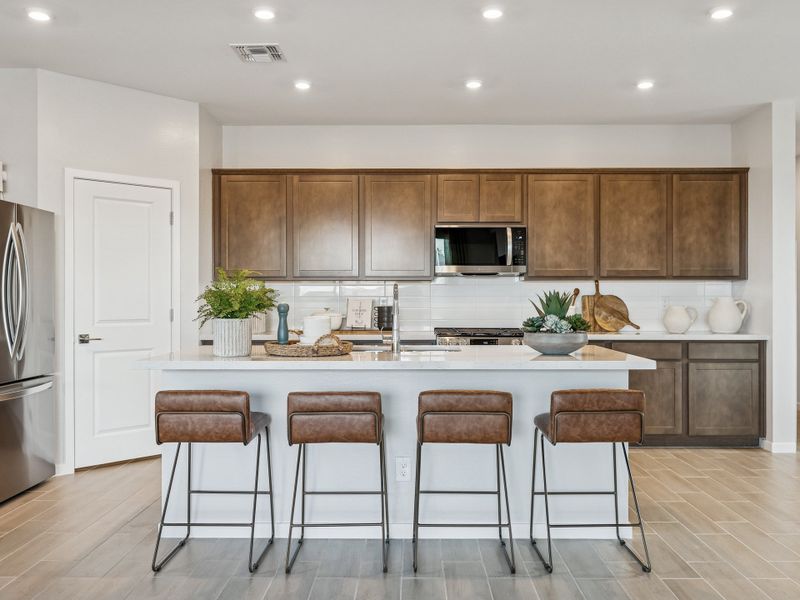 A kitchen with a marble island.