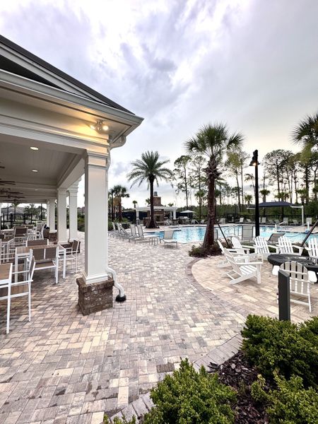 Elegant outdoor pool area with chic seating and lush landscaping in Summer Bay at Grand Oaks by Pulte Homes (St. Augustine, FL). Elegant outdoor pool area with chic seating and lush landscaping in Summer Bay at Grand Oaks by Pulte Homes (St. Augustine, FL).