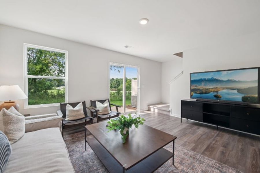 A living room with a large television. A living room with a large television.