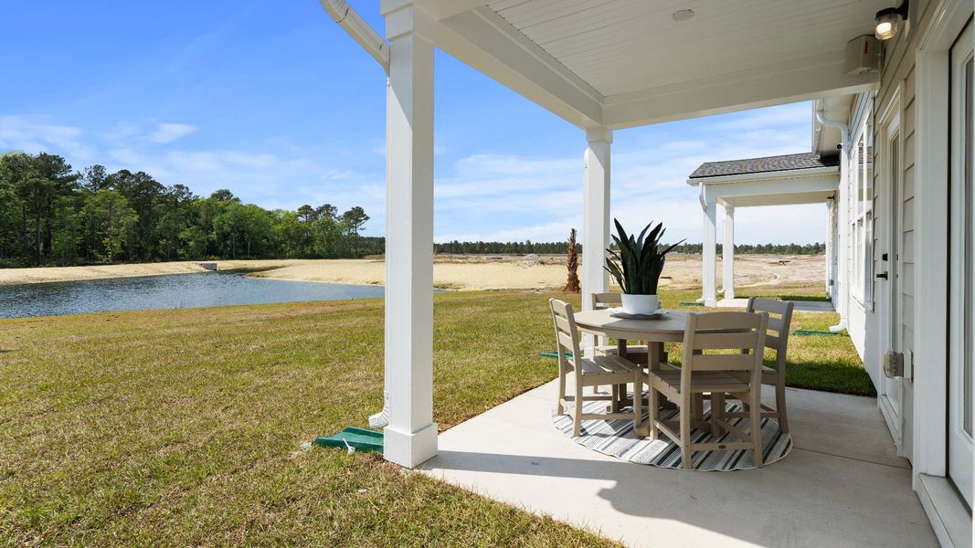 Covered rear porch in the Summit home plan offering outdoor living and relaxing views.