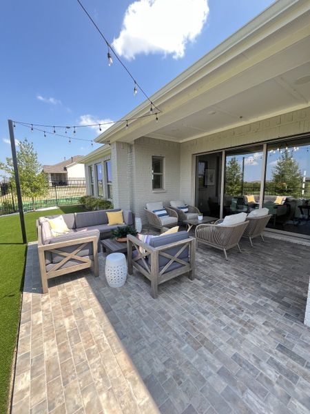 A charming patio with wicker seating, colorful cushions, and string lights, perfect for outdoor relaxation. A charming patio with wicker seating, colorful cushions, and string lights, perfect for outdoor relaxation.