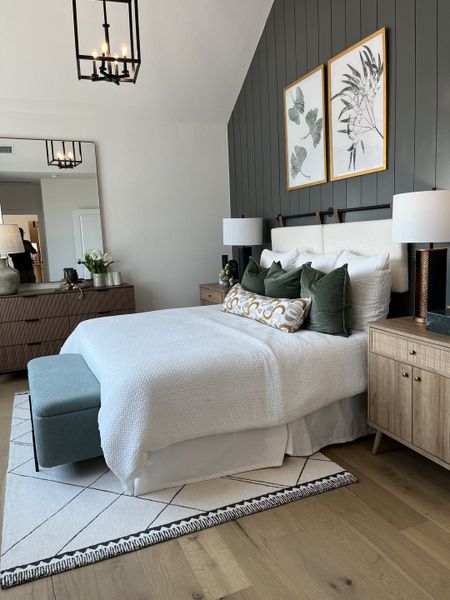 A cozy bedroom with a textured accent wall, tasteful artwork, and elegant furnishings. A cozy bedroom with a textured accent wall, tasteful artwork, and elegant furnishings.
