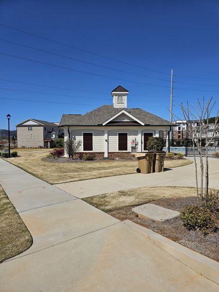 A charming clubhouse with manicured lawns in Brackley Single Family by The Providence Group, Cumming, GA.