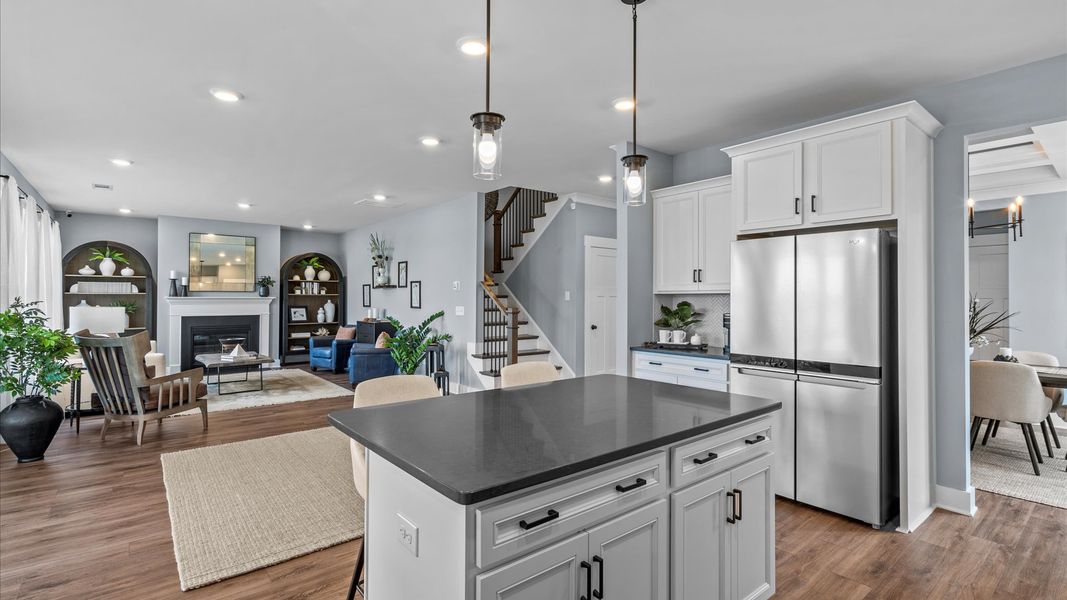 Stunning modern kitchen with black accents and pendant lighting in two story home at DRB Homes in Easley, SC