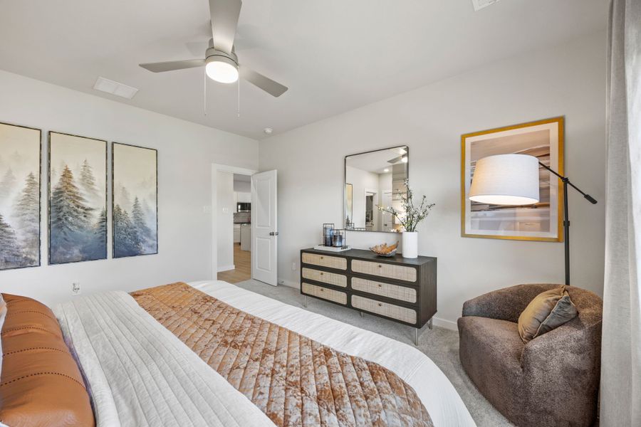 A bedroom with a bed and a couch.