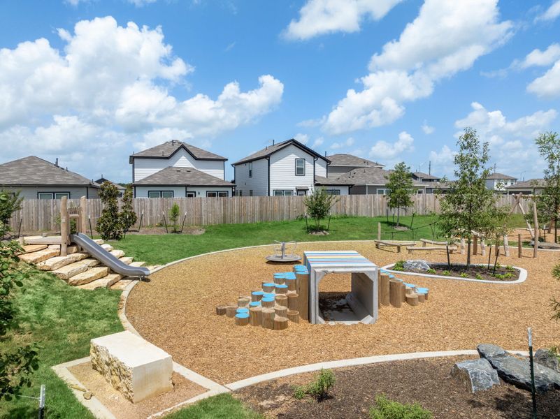 A backyard with a fence and a yard with a house in the background. A backyard with a fence and a yard with a house in the background.