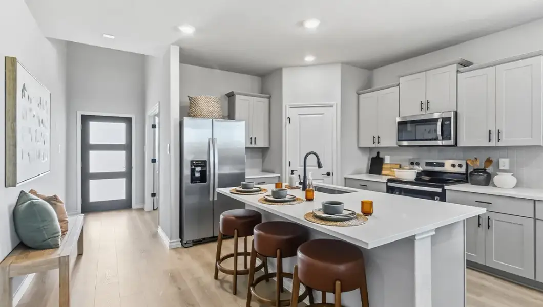 Furnished interior in a model home at The Woodlands at Medina Hills in Mico (Image 28).