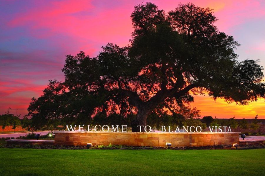 Entrance to the Blanco Vista community in San Marcos, TX, featuring signage and landscaping (Image 2). Entrance to the Blanco Vista community in San Marcos, TX, featuring signage and landscaping (Image 2).