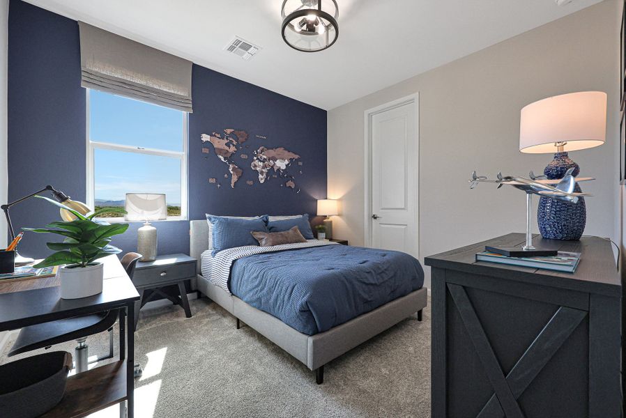 A bedroom with a bed desk and a lamp. A bedroom with a bed desk and a lamp.