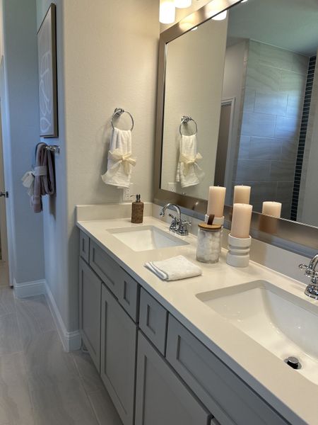 A modern bathroom with dual sinks, sleek cabinetry, and soft lighting, creating a serene and stylish space. A modern bathroom with dual sinks, sleek cabinetry, and soft lighting, creating a serene and stylish space.