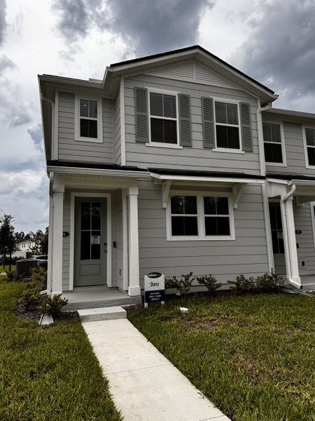 A charming gray two-story home with shutters in RiverTown - Meadows by Mattamy Homes (St. Johns, FL).