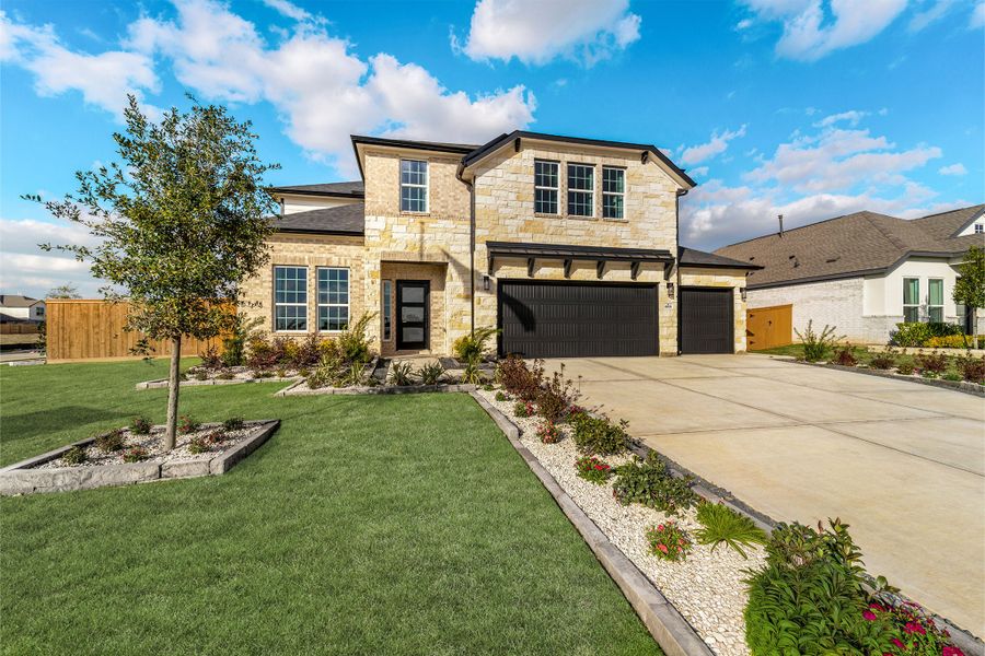 Front exterior of a home in the Sunterra Lakes community, located in Brookshire, TX (Image 2).