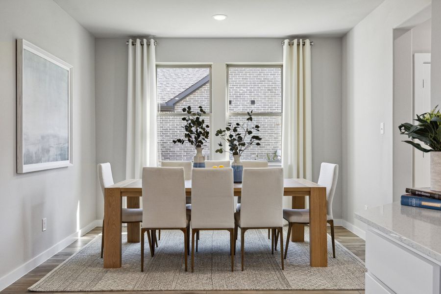 Dining Room in an Oak Model Home by Trophy Signature Homes
