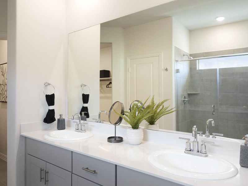 Your master bathroom retreat features double vanities