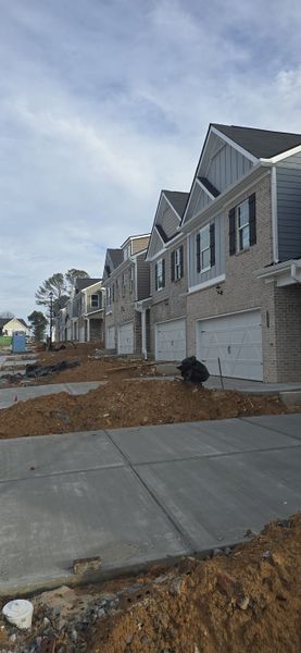 Newly constructed homes with modern brick facades at The Enclave at Cooper Creek by Direct Residential Communities (Grayson, GA).