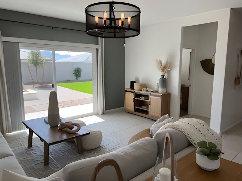 A cozy living room featuring neutral decor, a sleek coffee table, and a large sliding glass door to the patio.