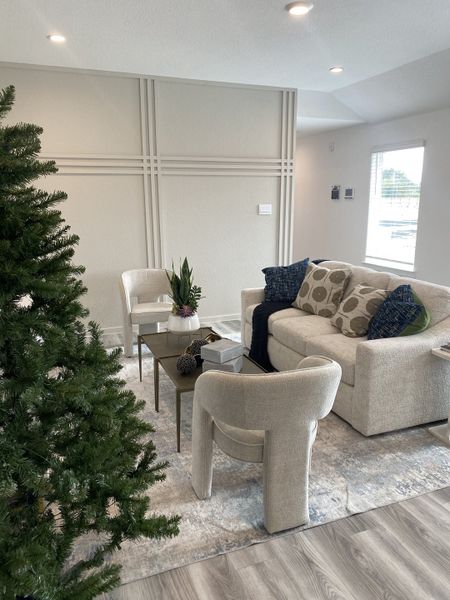 A cozy and inviting seating area with modern furniture, a plush area rug, and soft lighting.