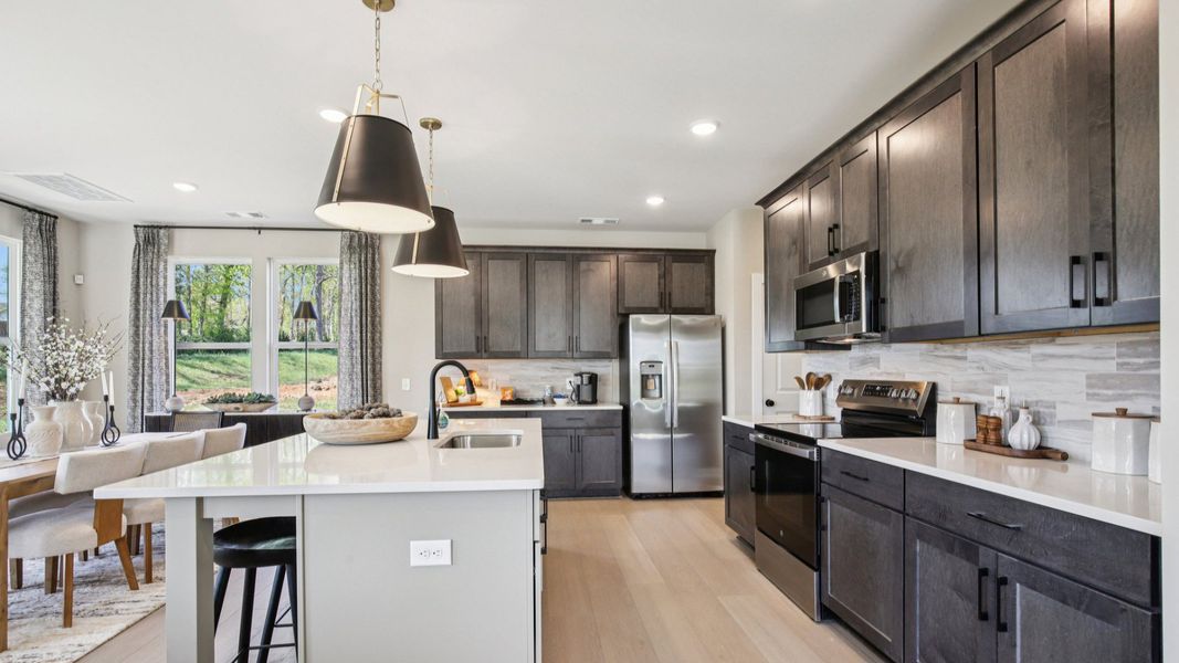 View of large Kitchen with island and nearby dining area