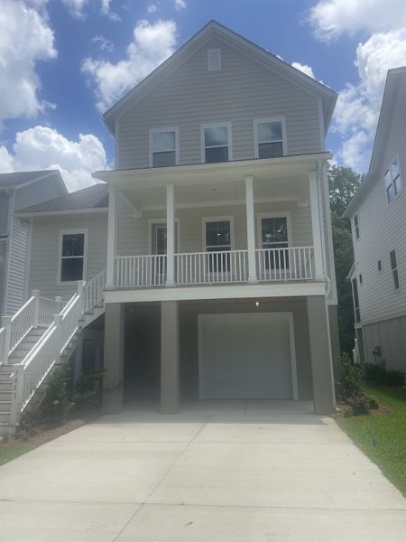 A charming multi-story home with a welcoming porch in Indigo Grove Single Family Homes by Stanley Martin Homes (Johns Island, SC).