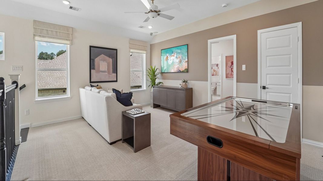 Luxurious open living area with chic black cabinetry, plush white seating, and ambient lighting in The Woodlands Hills.