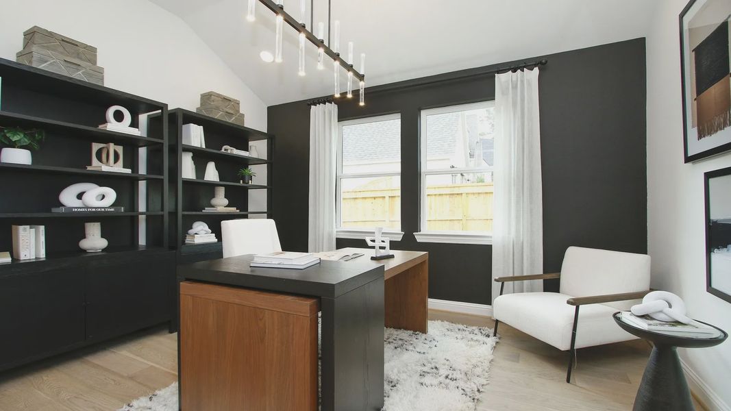 Experience sophistication with black shelves, sleek wood desk, and elegant decor in The Woodlands Hills.